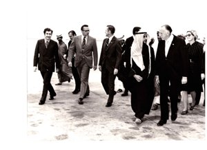 Dewey Bartlett walking across a runway with Fawaz Kudsi, Strang, Phillip Griffen, Faraj Hamoudah, Paul Fannin, Ann Bartlett, and several others, 1967-01-01 - 1978-12-31