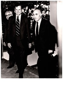 ["The image depicts Dewey Bartlett walking with Clifford Hansen and Nather Ohari"]