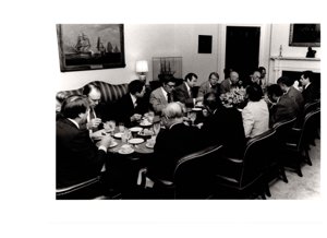 ["The image depicts Dewey Bartlett seated with several other men, including Jimmy Carter"]