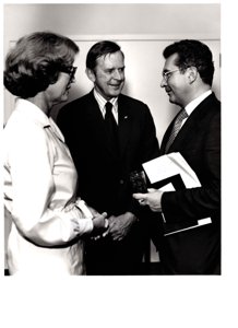 ["The image depicts Dewey Bartlett standing, talking with Dr. Ludwig Huber, Minister of Finance of Bavaria, and Ann Bartlett"]