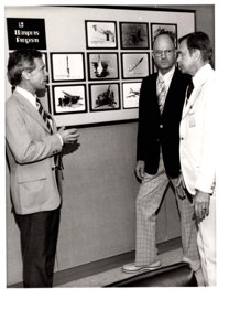 ["The image depicts Harry Reynolds (Associate Director of Lawrence Livermore Laboratory), Duane C. Sewell (Assistant Secretary for Defense Programs, Department of Energy), and Dewey Bartlett at the Lawrence Livermore Laboratory"]
