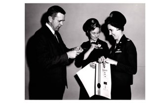 ["The image depicts Dewey Bartlett standing with two Air Force Officers, Lieutenant Astafan and Lieutenant Fletcher"]