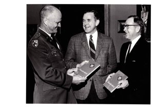 ["The image depicts Dewey Bartlett standing with Colonel Jack L. Treadwell and Colonel Roy P. Stewart"]