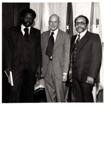 ["The image depicts Dewey Bartlett standing with Dan Palmer and Walter Block in his office"]