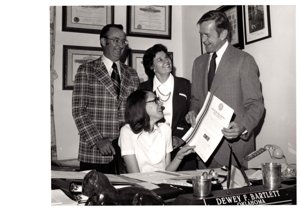 ["The image depicts Dewey Bartlett presenting Paula Merritt an Okie certificate"]