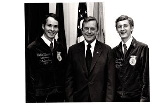 ["The image depicts Dewey Bartlett standing with Robin Osborn and Deo Saralosky, FFA Officers"]