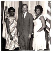 ["The image depicts Dewey Bartlett standing between Margie Barre and Paula Barre of the Tulsa Urban League"]