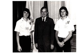 ["The image depicts Dewey Bartlett standing between Charles Kuykendall and Danie Tkach, two American Legion Boys Nation members"]