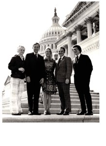 ["The image depicts Dewey Bartlett standing with Mary Weldon, Steph Irwin, Johnnie Cherblanc, and Tom Cantrell in front of the Capitol"]