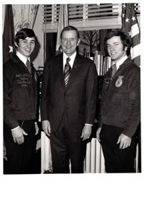 ["The image depicts Dewey Bartlett standing between Bart Brashears and Alpha Trinelle, two national officers for the FFA"]