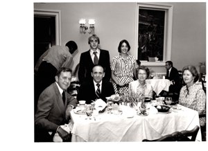 ["The image depicts Dewey Bartlett seated with Lew Ward and his family, and Ann Bartlett"]