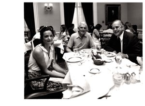 ["The image depicts Dewey Bartlett seated at a dinner table with Eillen and Ray Mortimer"]