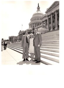 ["The image depicts Dewey Bartlett and Paula Unruh standing with Henry Bellmon on the steps of the Capitol"]