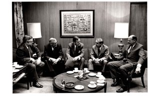 ["The image depicts Dewey Bartlett seated with (L to R) L. R. McClary, A. G. Foster, D. E. Procknow, and J. S. Heobert"]