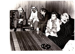 ["The image depicts Dewey Bartlett seated with Nather Omari, Rahma Masood, Clifford Hansen, Mrs. P. J. Griffen, and Ann Bartlett"]