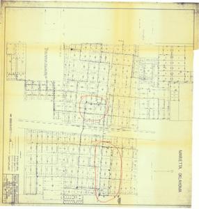 ["The document represents a map item is a watermain map of Marietta, Oklahoma and depicts the city's existing water supply system. Two areas of the map are circled in red ink. These areas contain the 1962 revisions of proposed fire hydrants, valves, and new mains. Watermain map (diazotype, blueline print); 34 9/16 x 35 5/8 inches; Annotations (circles; red, ink)."]